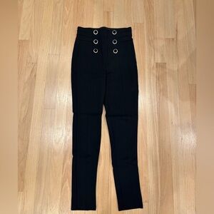 Black high-waisted legging pants with silver accent buttons